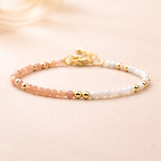 Bracelet with pink and white beads on a beige background