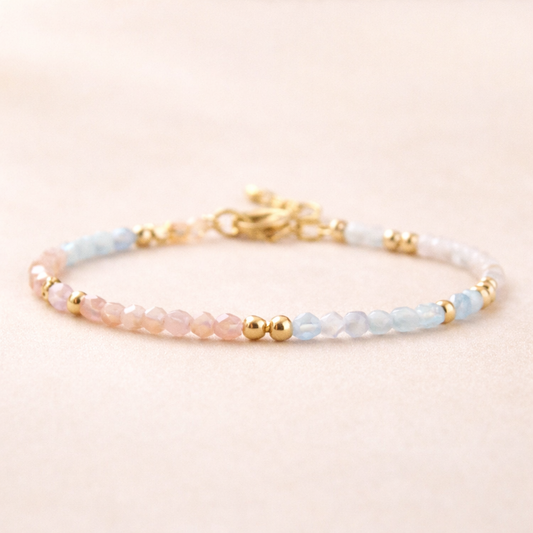 Beaded bracelet with gold accents on a beige background