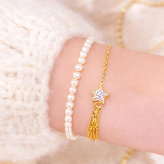 Gold bracelet with star and tassel design